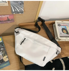 Close-up of white waterproof crossbody bag with black nylon strap and BÜFAN label