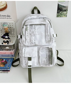 Detailed close-up of white canvas backpack featuring olive green straps and Chinese calligraphy