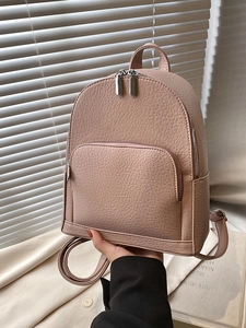 Minimalist nude pink pebble leather backpack with silver hardware for women
