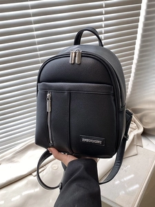 Fashionable black pebble leather backpack for women with adjustable straps and metal logo