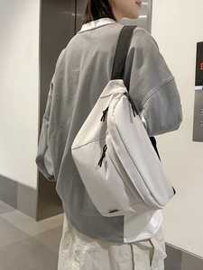 Minimalist white nylon crossbody bag for men with black shoulder strap and double zippers