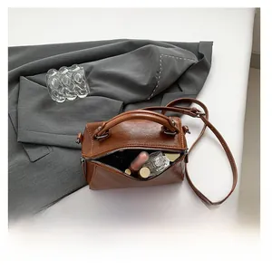 Top view of brown leather crossbody bag showing interior storage capacity for essentials