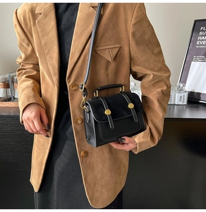Fashionable retro black crossbody bag with leather stitching and gold buckle detail