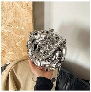 Detail of silver rose evening bag featuring metallic petals and beaded handle