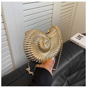 Detailed view of snail shell evening bag featuring golden metallic finish and chain