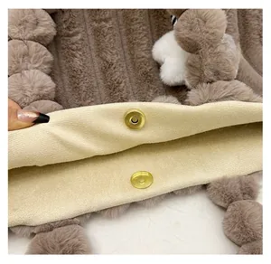 Macro view of gold magnetic snap closure and soft plush fabric texture on tote bag