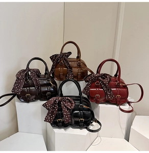 Group shot of four vintage bowling bags in glossy colors with polka dot ribbon details