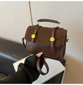 Detail of vintage crossbody bag with dark brown faux leather and suede patchwork design