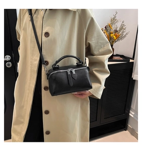 Detailed view of the black matte leather mini square bag with silver metal zippers