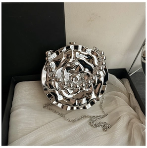 Detail view of silver 3D rose flower evening clutch bag with metallic chain strap