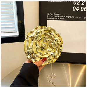 Detailed view of a gold rose-shaped evening bag with metallic petals and slim chain strap