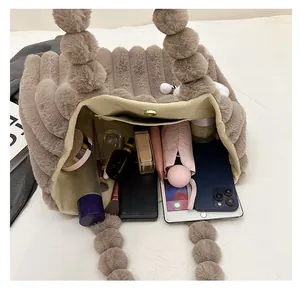 Macro shot of large capacity plush tote bag interior with magnetic buckle and pockets