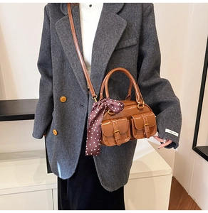 Brown gloss bowling bag with front pockets and elegant silk scarf detail on handle