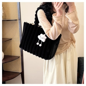 Detail of black faux fur tote bag with vertical pleated texture and cloud charm