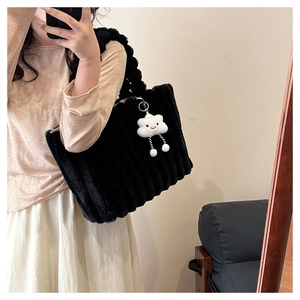 Detail of black faux fur tote bag with striped texture and cute cloud charm