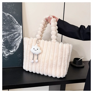 Close-up of cream faux fur tote bag with bubble handle and cloud pendant decoration
