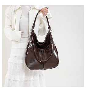 Détail du sac Hobo en cuir verni marron foncé brillant avec ornements métalliques
