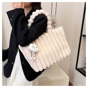 Close-up of white plush tote bag with striped texture and cloud charm detail
