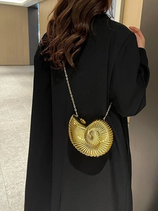 Golden snail-shaped acrylic clutch bag with luxury metallic finish and chain strap