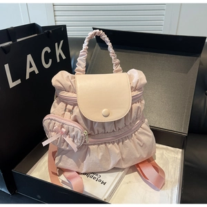Pink pleated nylon backpack with a mini pouch in a luxury gift box setting