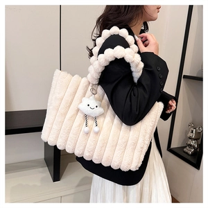 Plush cream white tote bag with textured stripes and cute cloud charm on a model