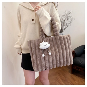 Detail of khaki plush tote bag with ribbed texture and fuzzy ball handle decor