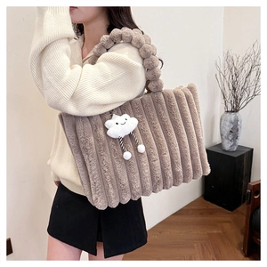 Brown faux fur tote bag featuring vertical quilted stripes and cute cloud charm accessory