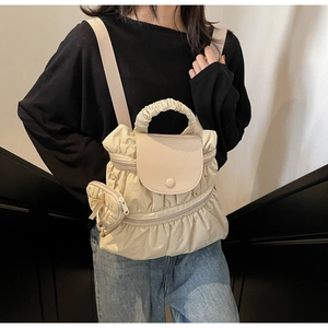 Detail of off-white pleated backpack with ruffle trim and mini round coin pouch