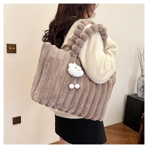 Detailed view of coffee plush tote bag with striped texture and cloud charm