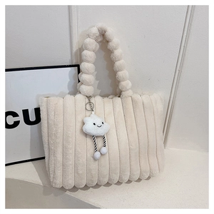 Detail of off-white plush tote bag featuring bubble handles and cloud charm detail