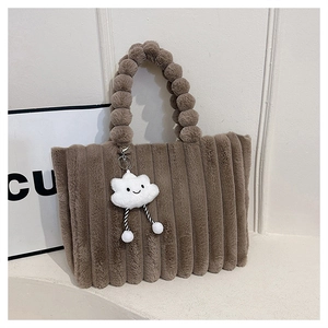 Detail of brown plush tote bag with striped faux fur texture and a cute cloud charm