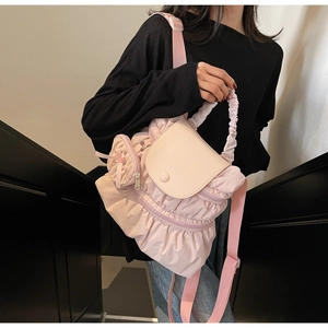 Detailed view of pink ruffled backpack with adjustable straps and sweet pleated design
