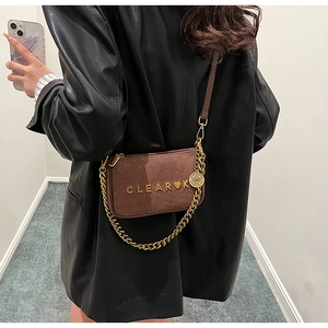 Close-up of brown frosted leather crossbody bag with gold chain and CLEAR K logo detail