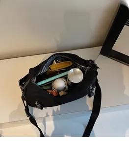 Innenansicht der großen Kapazität und des blau gestreiften Futters dieser schwarzen Tasche