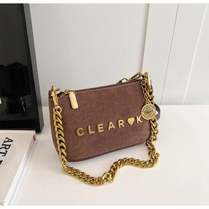 Detailed close-up of dark brown matte texture with golden metal chain and clear logo buckle