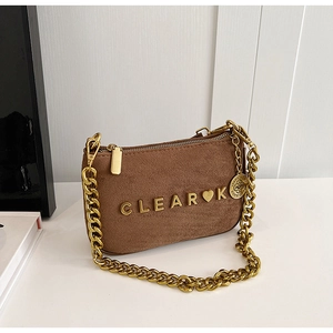 Detail of brown matte shoulder bag with gold 3D metal letters and thick chain strap