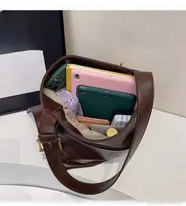 Spacious interior of a dark brown tote bag showing organized daily essentials