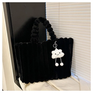 Close-up of black plush tote bag with quilted texture and white cloud charm accessory