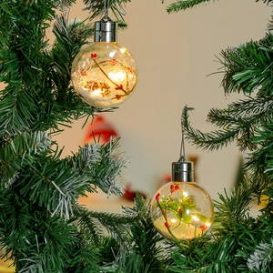 Pallina di Natale luminosa con luci LED calde e neve artificiale all'interno della sfera