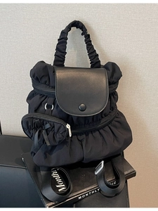 Fashionable black pleated nylon backpack with cloud handle and bow charm detail