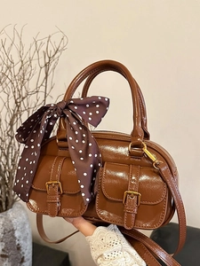 Brown vintage bowling bag with front pockets and polka dot scarf accessory