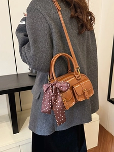 Retro brown glossy Boston bowling bag with metal buckles and polka dot silk scarf