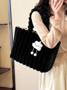 Fashionable black plush tote bag with striped texture and white cloud charm shown on model