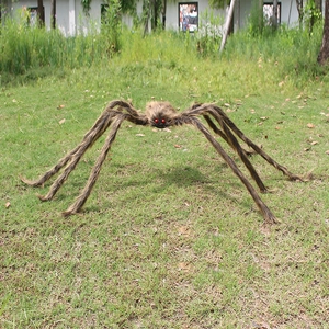 Giant Halloween plush spider decoration with red eyes and brown fur for outdoor lawn decor