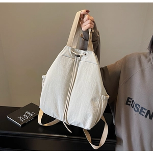 Détail d'un sac à dos beige à cordon en nylon avec une poche latérale pratique