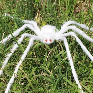 Close-up of a giant white plush spider with red eyes for Halloween outdoor decoration