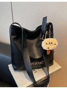 Black leather tote bag with Summer print and a cute biscuit plush charm on books