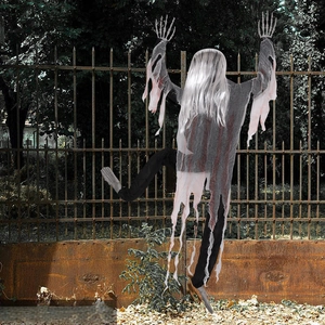 Detailed close-up of a climbing zombie Halloween prop with fake blood and bone hands