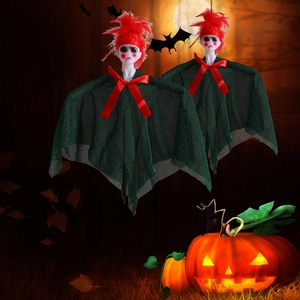 Detail of hanging Halloween ghost decor with green tulle cape and red feather hair accessory