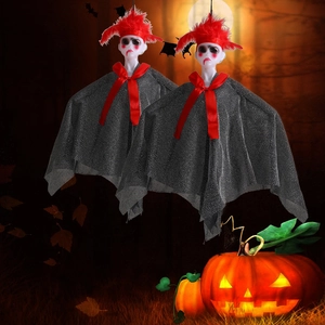 Hanging Halloween ghost decorations with red feathers and black capes in a night setting